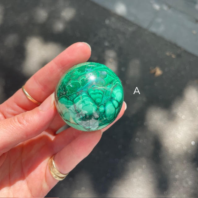 Malachite Spheres | Beautiful material from the Congo | Complex and fascinating swirls and rosettes | Pockets and caves sparkle with crystalline Malachite | Genuine Gems from Crystal Heart Melbourne Australia since 1986
