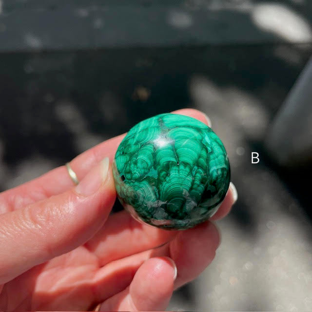 Malachite Spheres | Beautiful material from the Congo | Complex and fascinating swirls and rosettes | Pockets and caves sparkle with crystalline Malachite | Genuine Gems from Crystal Heart Melbourne Australia since 1986
